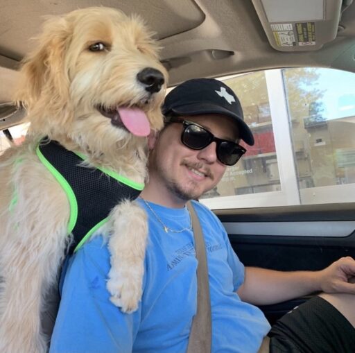 man with dog in harness