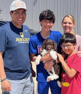 bordoodle puppy with family