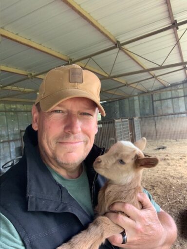 farmer with baby goat