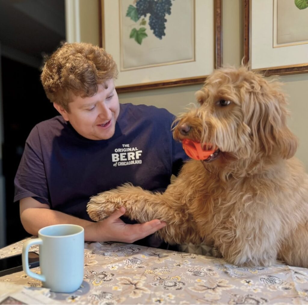 man with goldendoodle